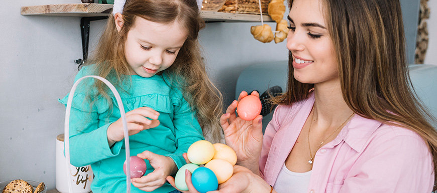Mom and daughter holding easter eggs